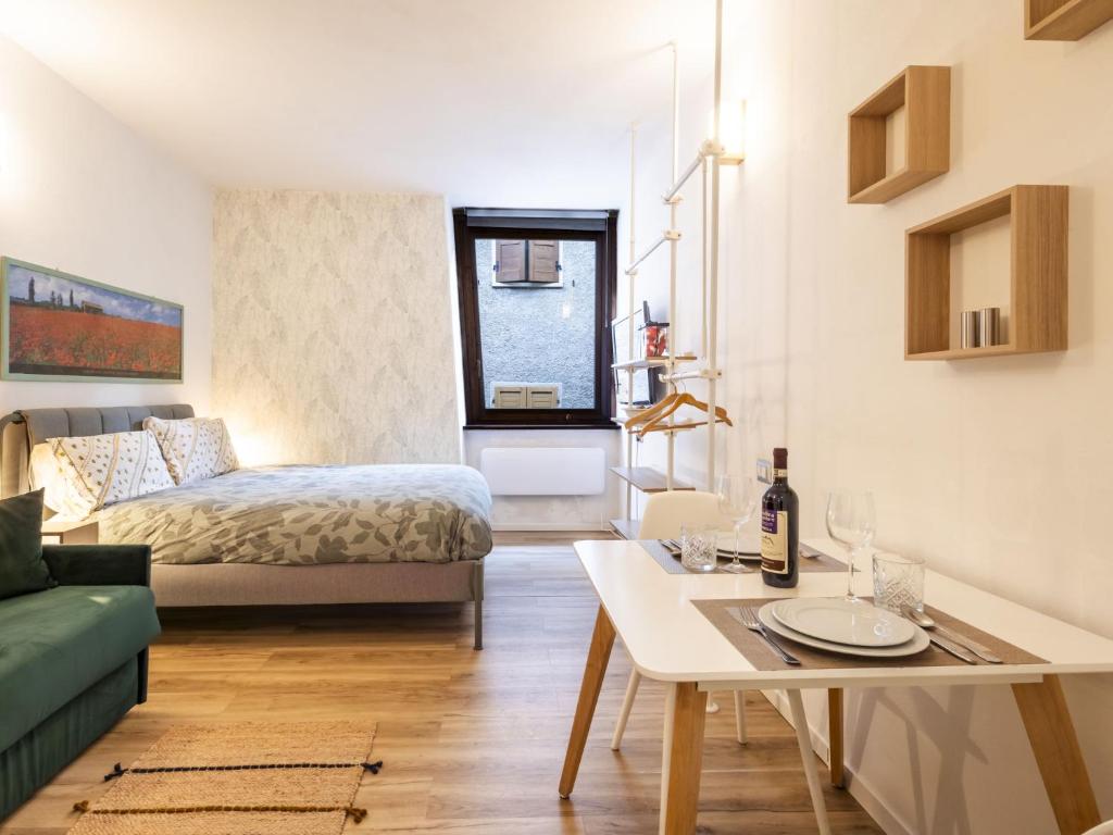 a living room with a bed and a table at Studio Studio T by Interhome in Bormio