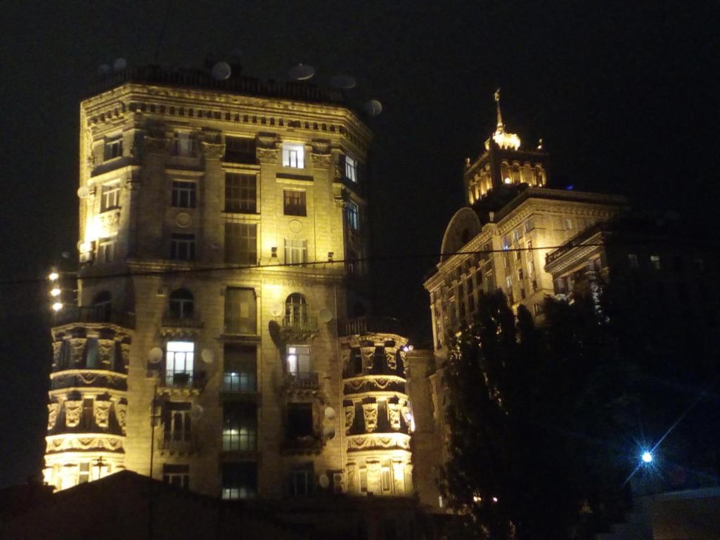 a tall building with lights on it at night at Smile Khreschatyk Kyiv in Kyiv