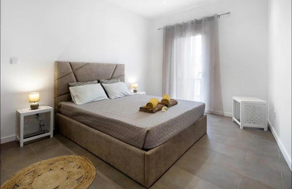 a bedroom with a bed with two teddy bears on it at Capelas Pdl Apartment in Ponta Delgada
