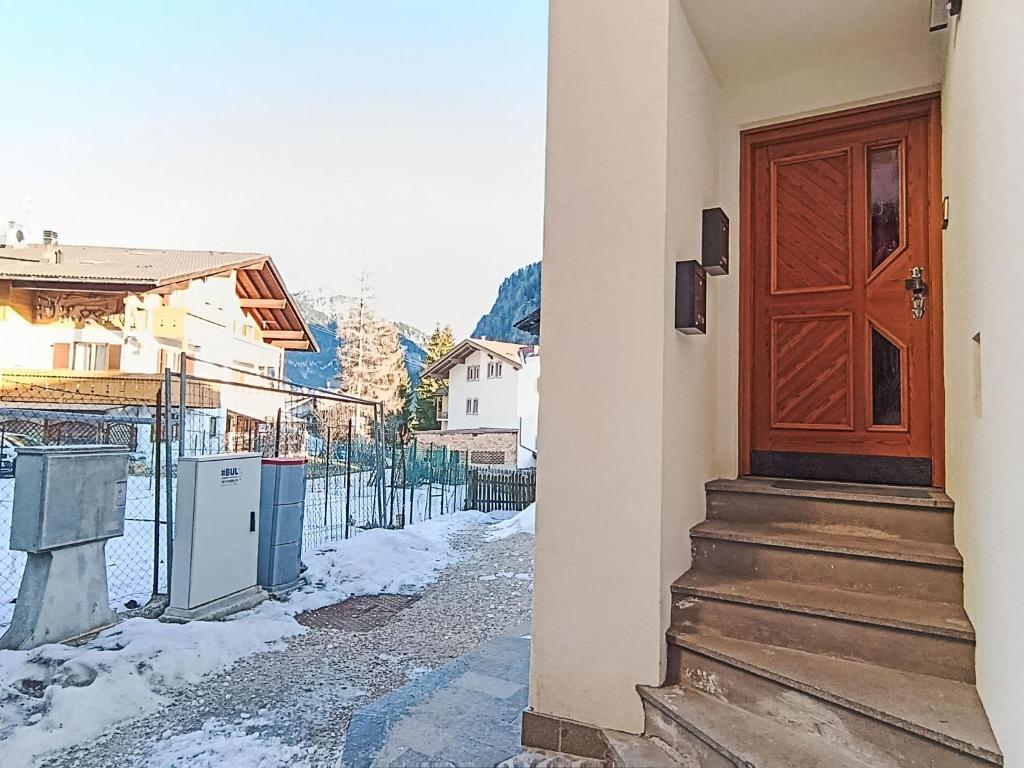 a door of a house with snow on the ground at Apartment Cesa Cristina by Interhome in Campitello