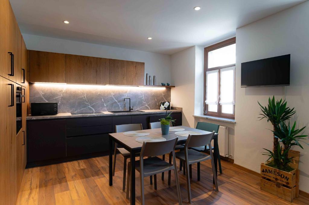 a kitchen and dining room with a table and chairs at Casa vacanza Garcia in Paluzza