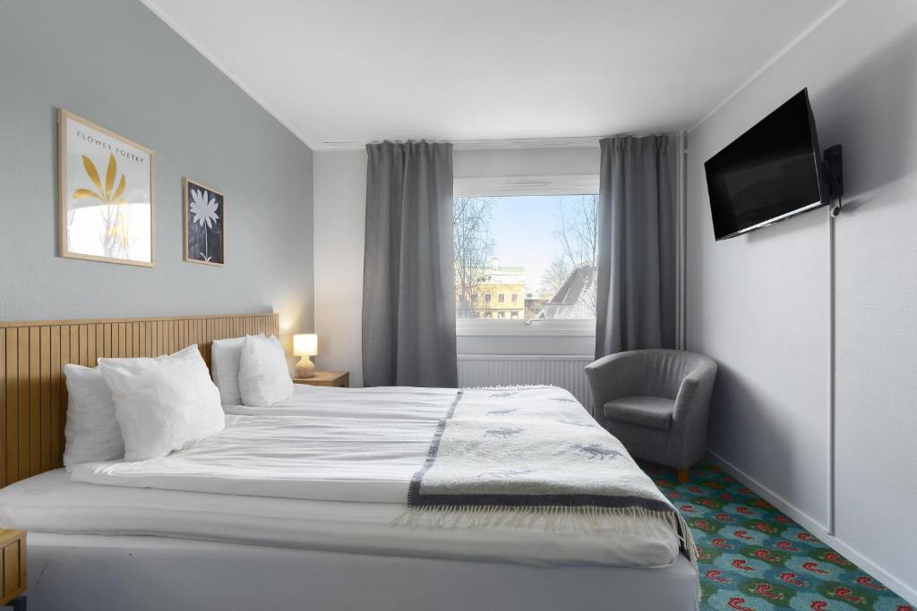 a hotel room with a bed and a window at Best Western Hotel Bollnas in Bollnäs