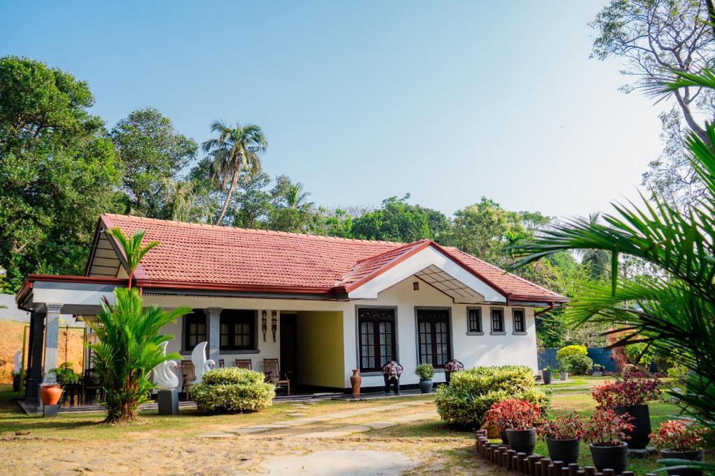 a small house with a red roof at Zeylon Villa Talalla in Matara
