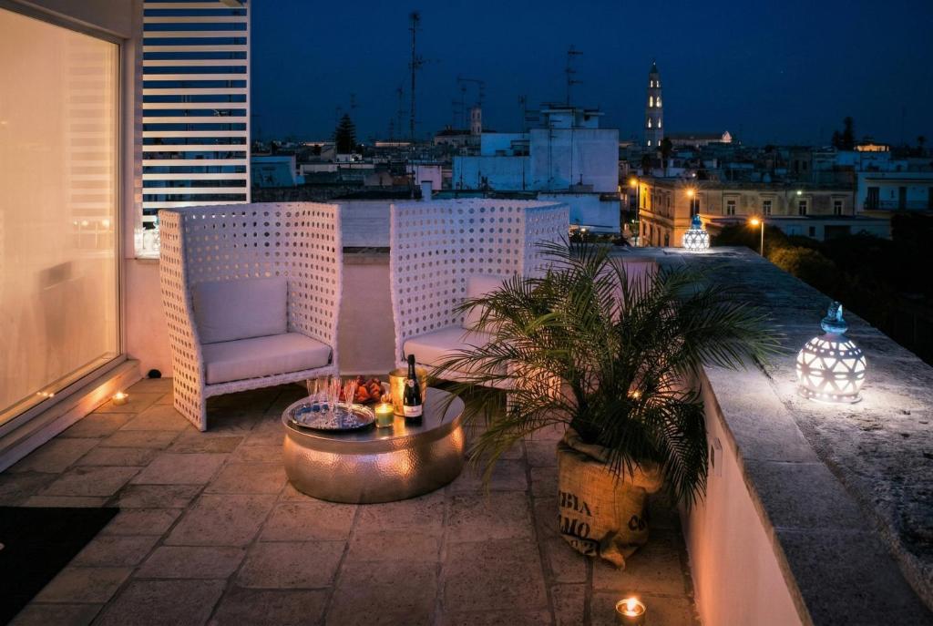 a patio with a chair and a table on a balcony at B&B Il Palazzotto di Luca Luxury Suites in Lecce