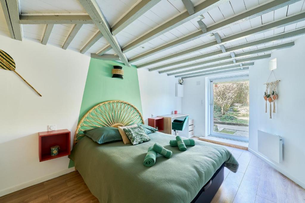 a bedroom with a large bed with a large window at Ker Berthe - Maison spacieuse - lumineuse - 4 chambres in Cesson-Sévigné
