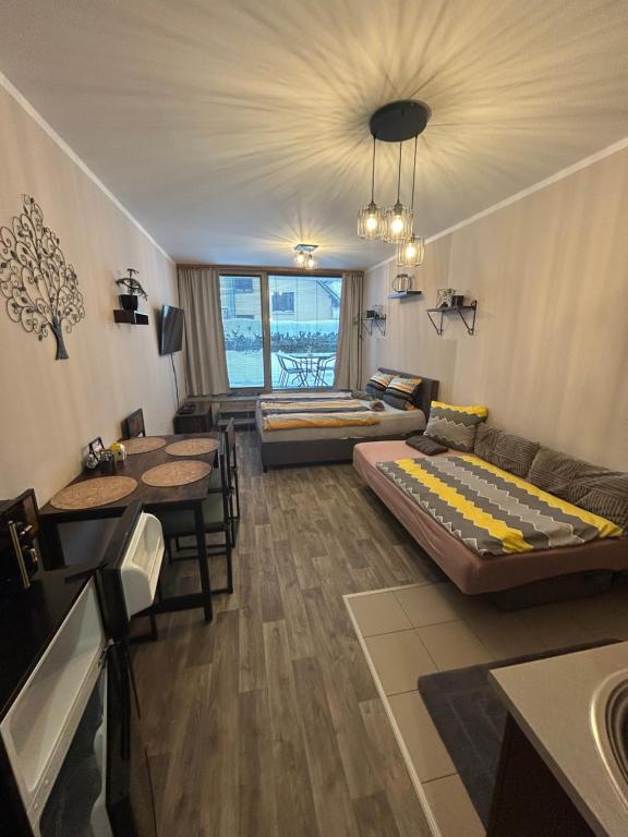 a living room with two beds and a couch at Apartmán Míša in Harrachov