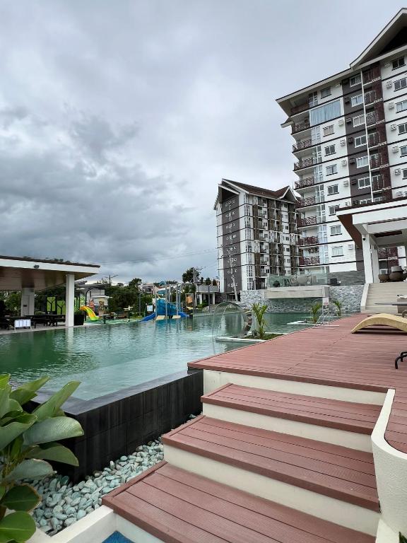 a swimming pool in a resort with a water park at Antara Residential Condominium in Talisay