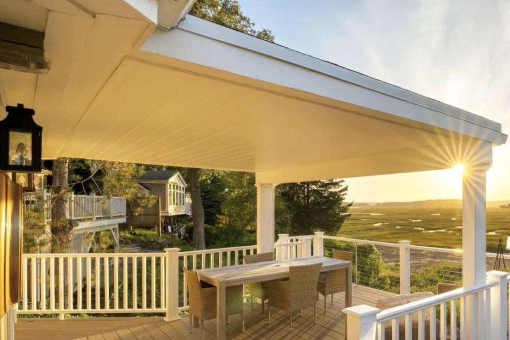 a white porch with a table on a deck at Perfectly Scitu8ed - Scituate in Scituate