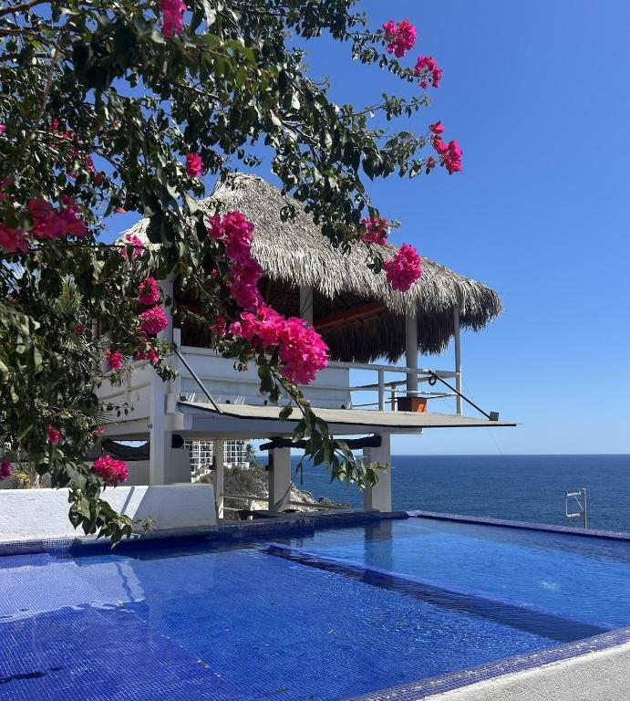 a view of a resort with a swimming pool and the ocean at Casa PuntaBlanca in Puerto Ángel