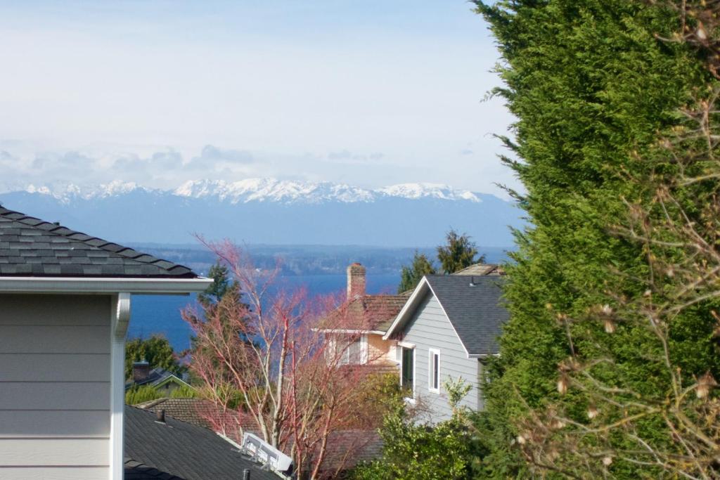 a view of snow covered mountains from a house at Saltwater Shoreline in Shoreline
