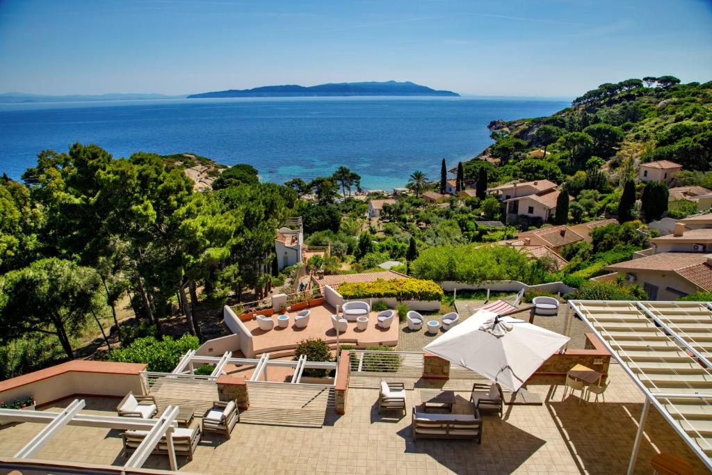 a resort with a view of the ocean at Hotel L'Arenella in Giglio Porto
