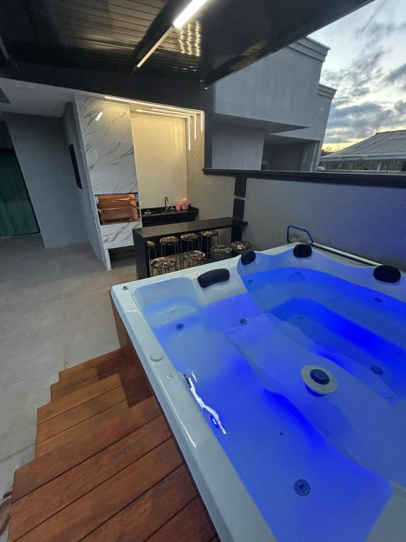 a large blue bath tub in a room at Beautiful Cozy Beach House Accommodation in Guaratuba