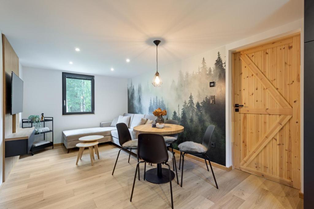 a living room with a table and a couch at Chata 01 in Čeladná