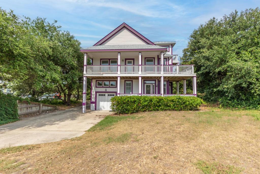 a large pink house with a large yard at 4751 - Purple Passion in Kitty Hawk Beach