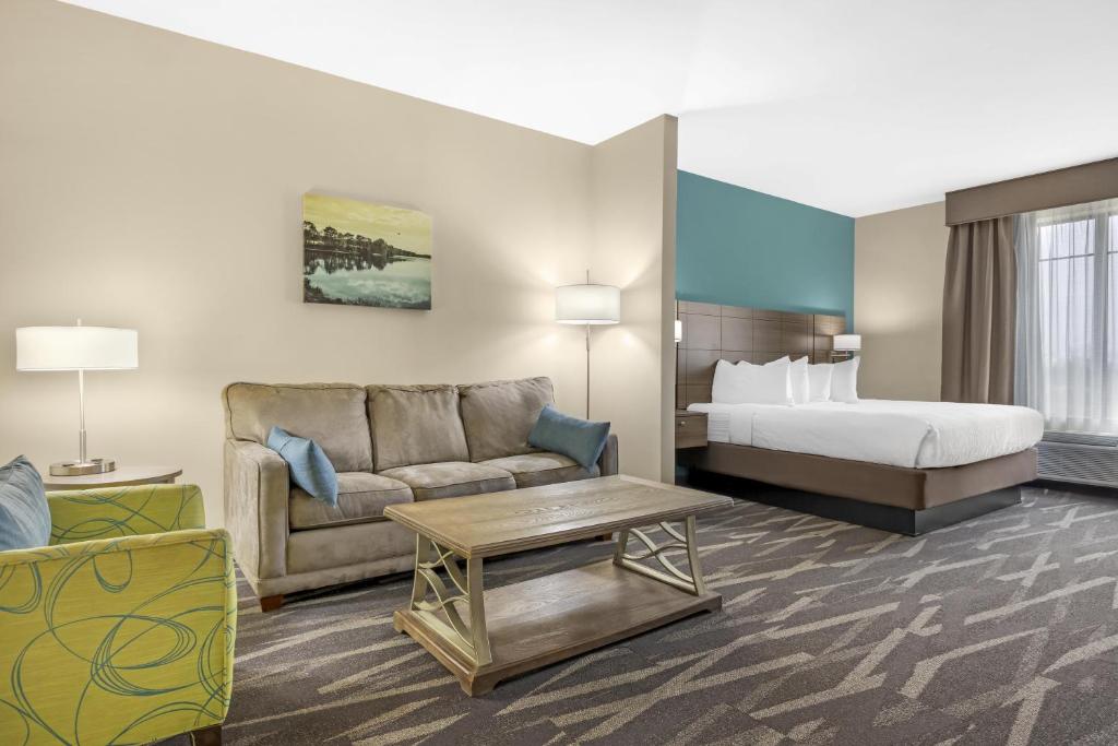 a hotel room with a bed and a couch at Best Western Plus Centralia Hotel & Suites in Centralia