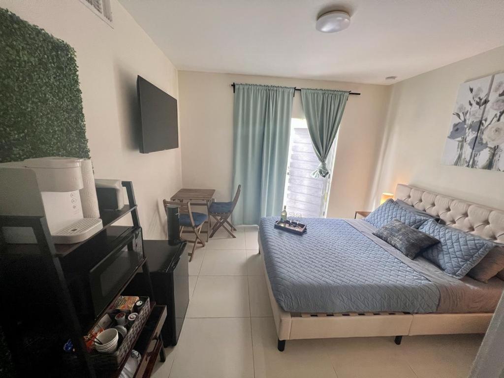 a bedroom with a bed and a table in it at Studio apartment- private entry! in Homestead