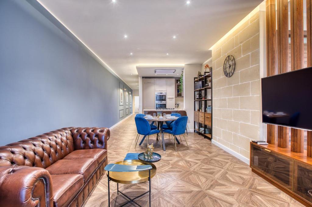 a living room with a couch and a table at NEW - Unique 3BR Apartment in Sought-After Area of Malta by SF Homes in Hal Ghaxiak
