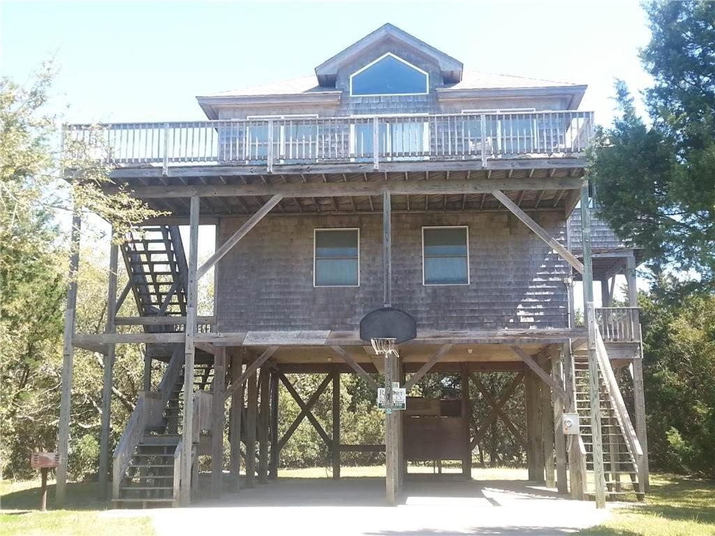 a large wooden house with a balcony and stairs at 7838 - Wilder View in Frisco