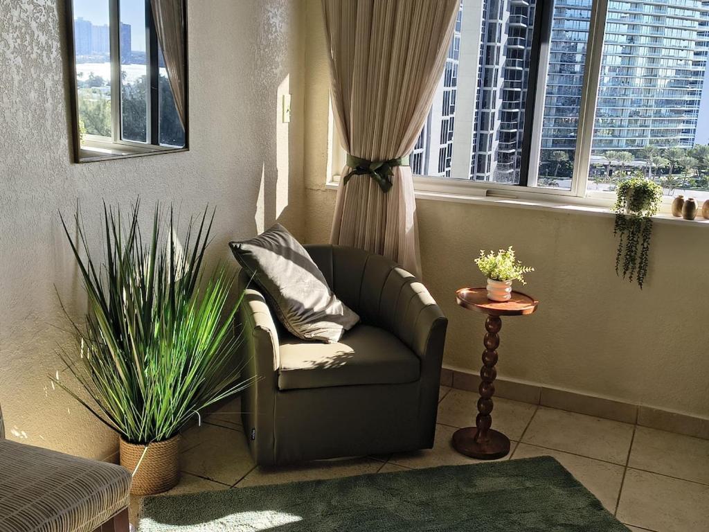 a living room with a chair and a window at Condo-Hotel on Collins ave in Sunny Isles Beach