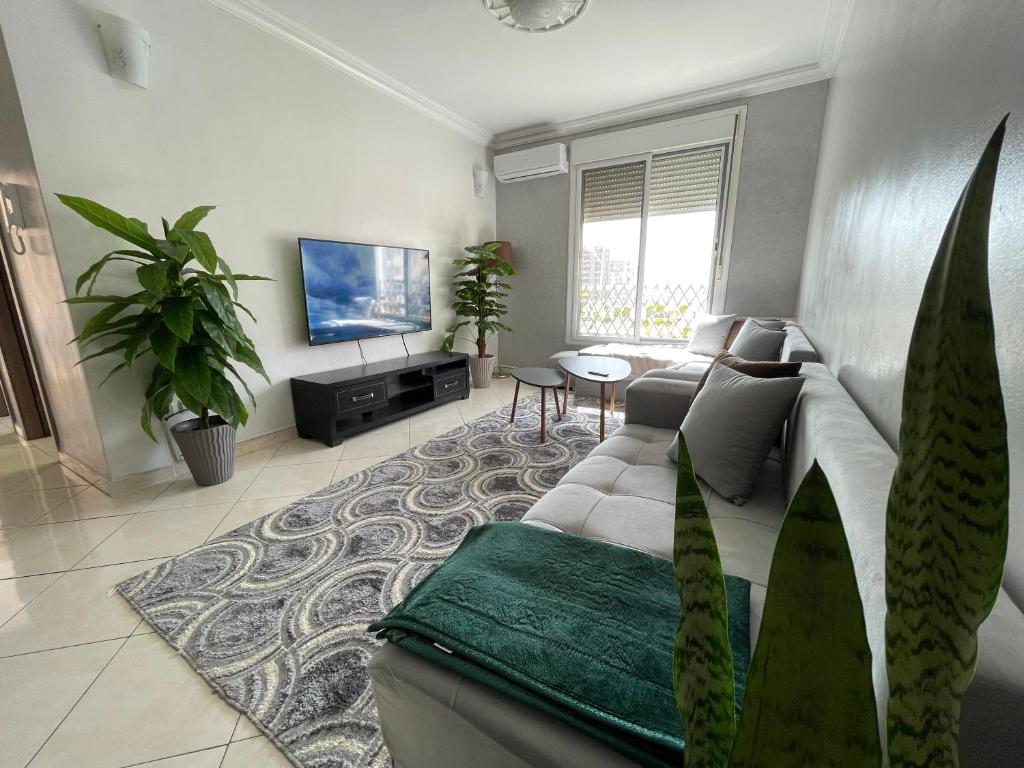 a living room with a couch and a table at Swiss Home in Agadir