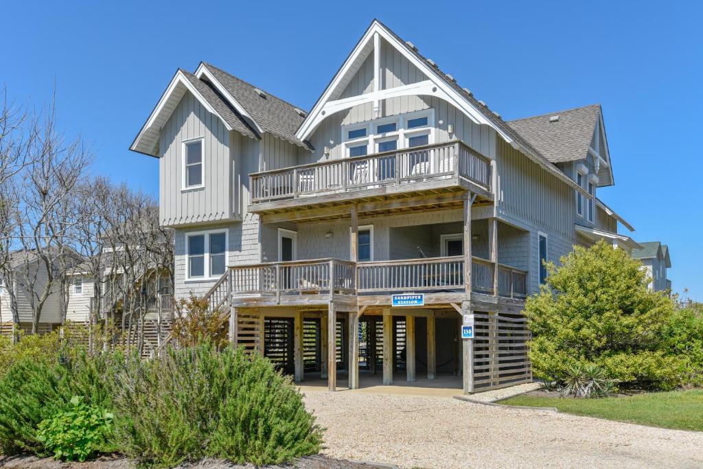 a large house with a porch and a balcony at 2437 - Sandpiper Station in Duck