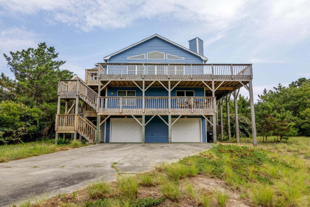 a house on the beach with a deck at 3213 - Seaside Salvation in Duck