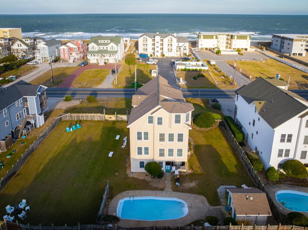an aerial view of a town with houses and the ocean at 5195 - Captain's Choice in Kill Devil Hills
