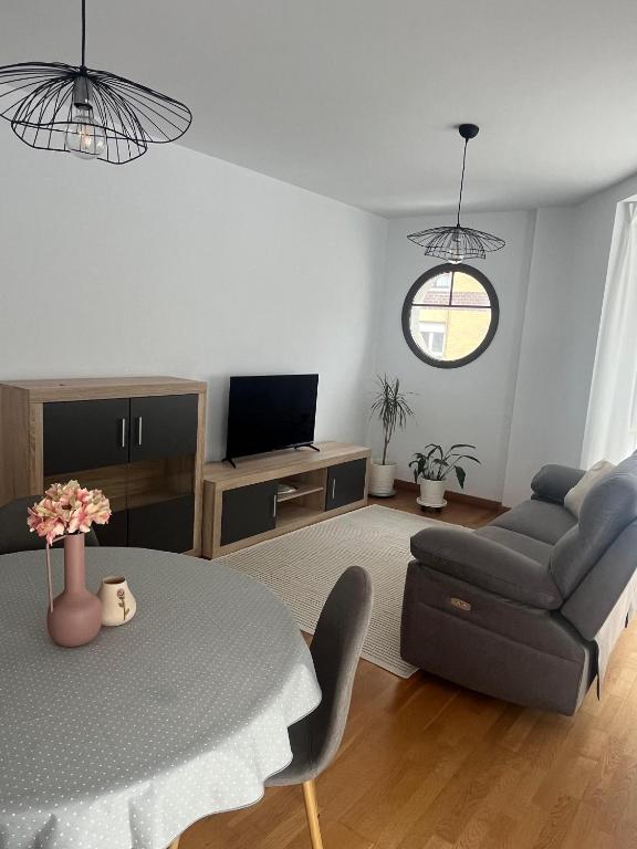 a living room with a table and a couch at El rincon del Cares in Panes