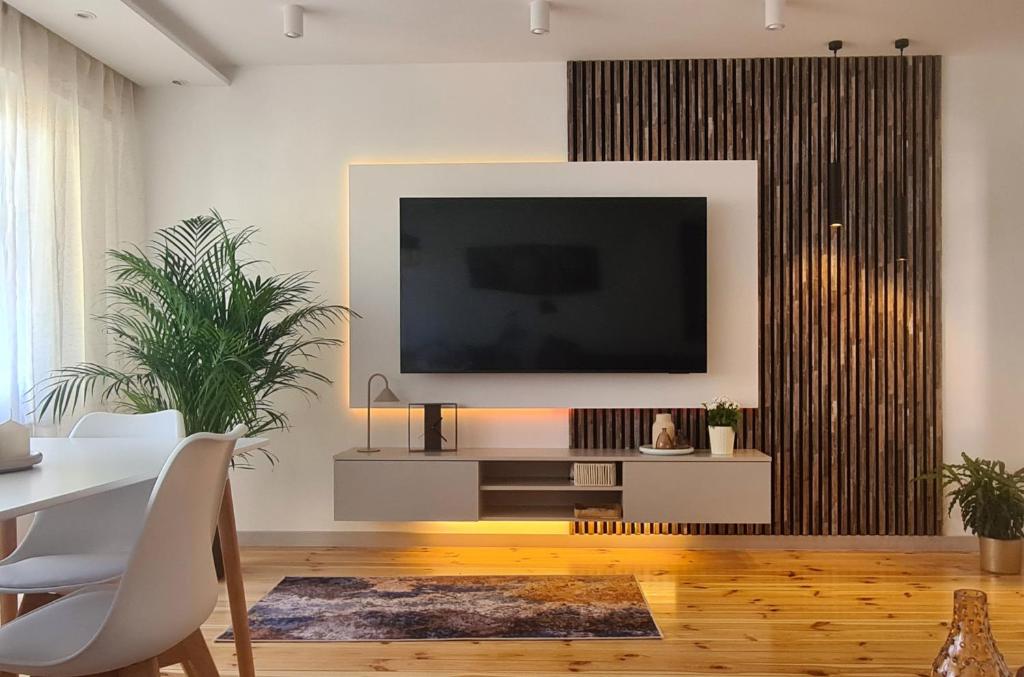 a living room with a flat screen tv on a wall at TARNO Lake Apartment in Tarnobrzeg