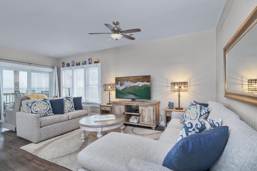 a living room with two couches and a tv at 7660 - Robyn's Nest in Avon