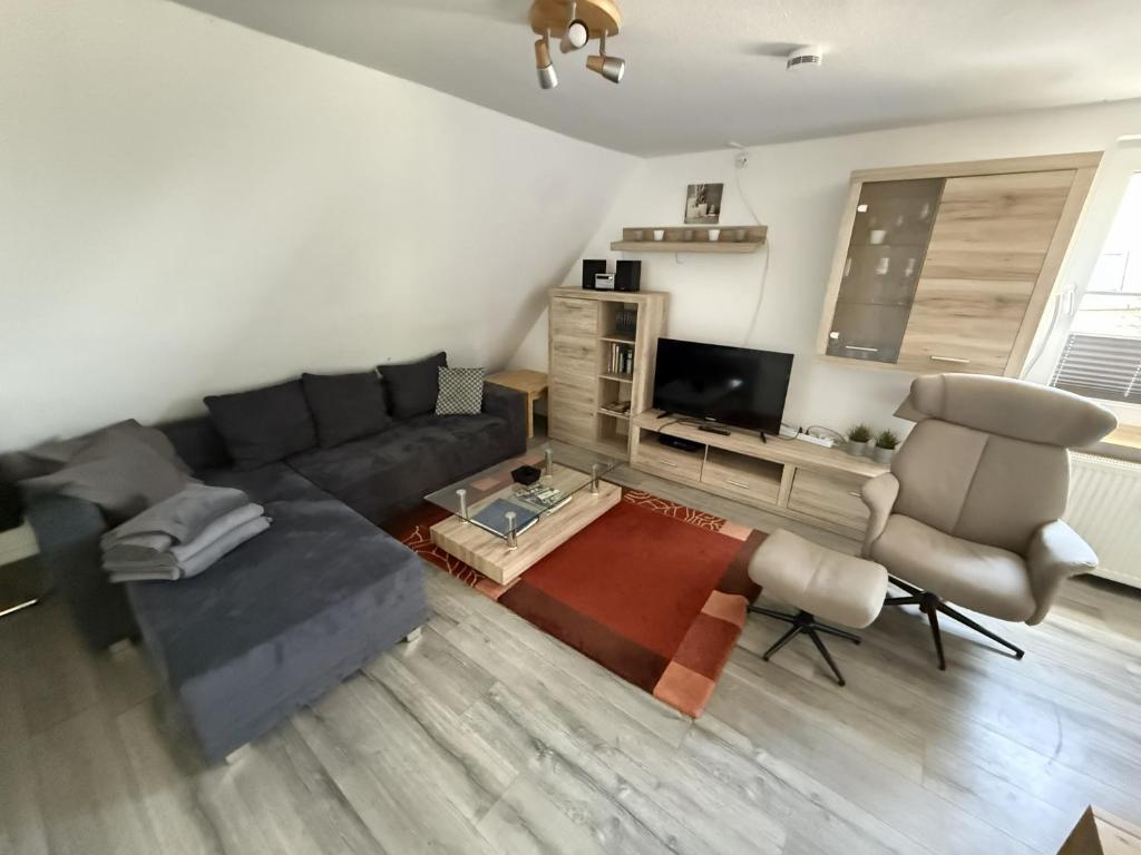a living room with a couch and a tv at FeWo Heaven in Winterberg