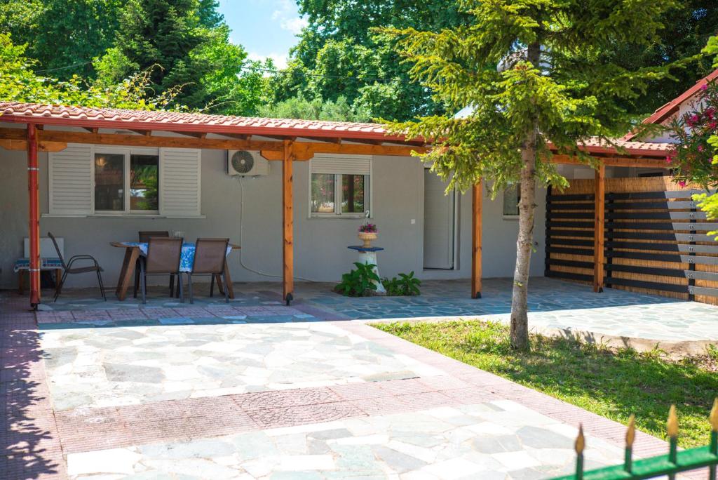 a patio with a table and a house at Ektoras House in Platamonas