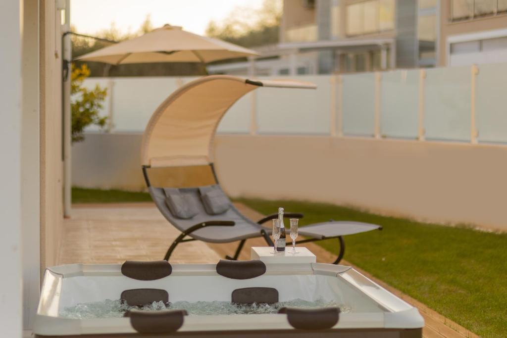 a chair and a table on a patio at Sinarca Elysium Apartment in Termoli