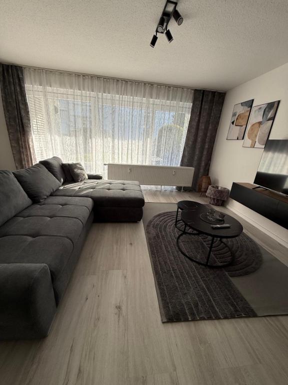 a living room with a couch and a table at Ferienwohnung Evelina in Bad Neuenahr-Ahrweiler