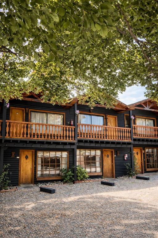 a large wooden house with a deck on it at Apart Hotel Blumenau in Osorno