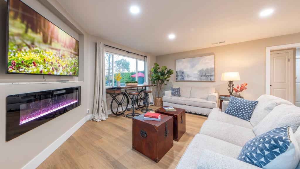 a living room with a large flat screen tv at Folsom Old Town Escape in Folsom