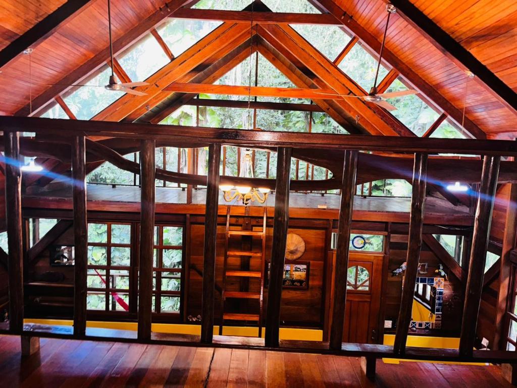 a large wooden building with a large window at Beyond Paradise Vacation Rental in Cristo Rey