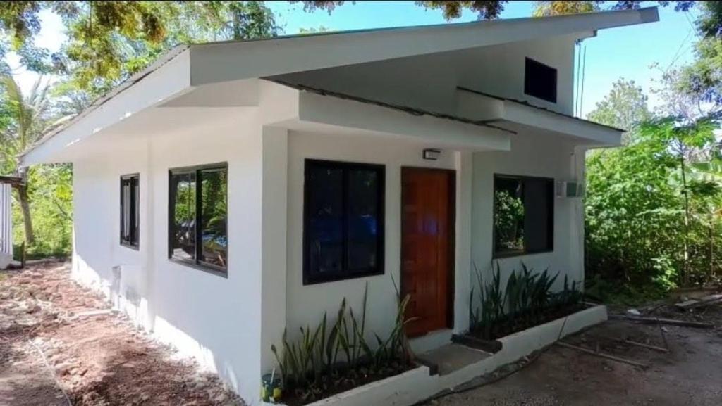 a small white house with a red door at Seanna's Inn in San Juan