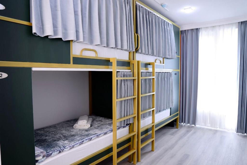 a bedroom with two bunk beds in a room at Beshic Hostel in Tashkent