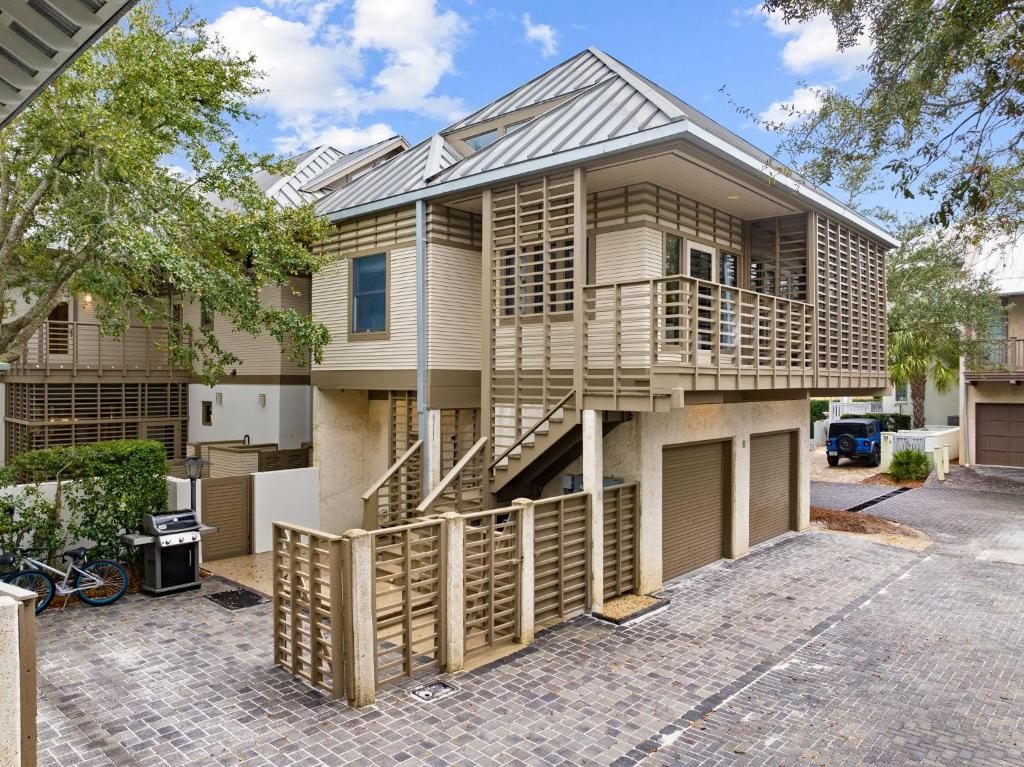 a house with a staircase in front of it at Brighton Carriage House in Rosemary Beach