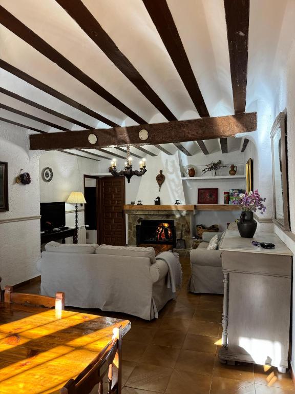 a living room with a couch and a fireplace at La Casa de Dori in Beteta