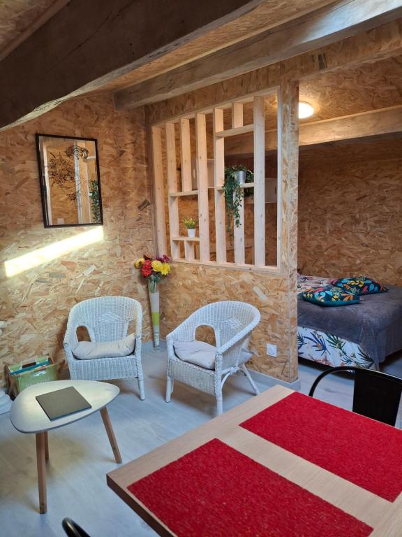 a living room with two chairs and a couch at Chez Marie in Le Pallet