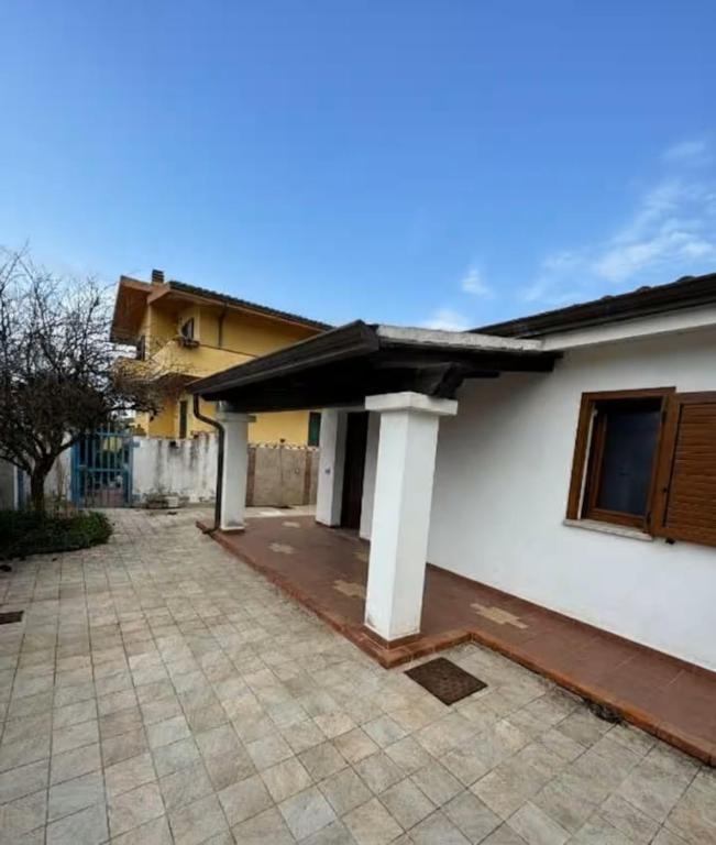 a white house with a porch and a patio at Da Anna Casa Vacanza Al Mare in Santa Lucia