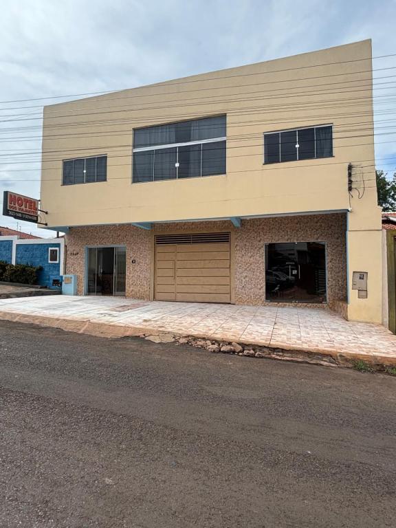 a large building with two garage doors on a street at Apartamento tecnoshow in Rio Verde