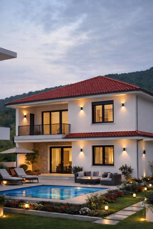 a house with a swimming pool in front of it at Visnjeva Gardens in Višnjevo