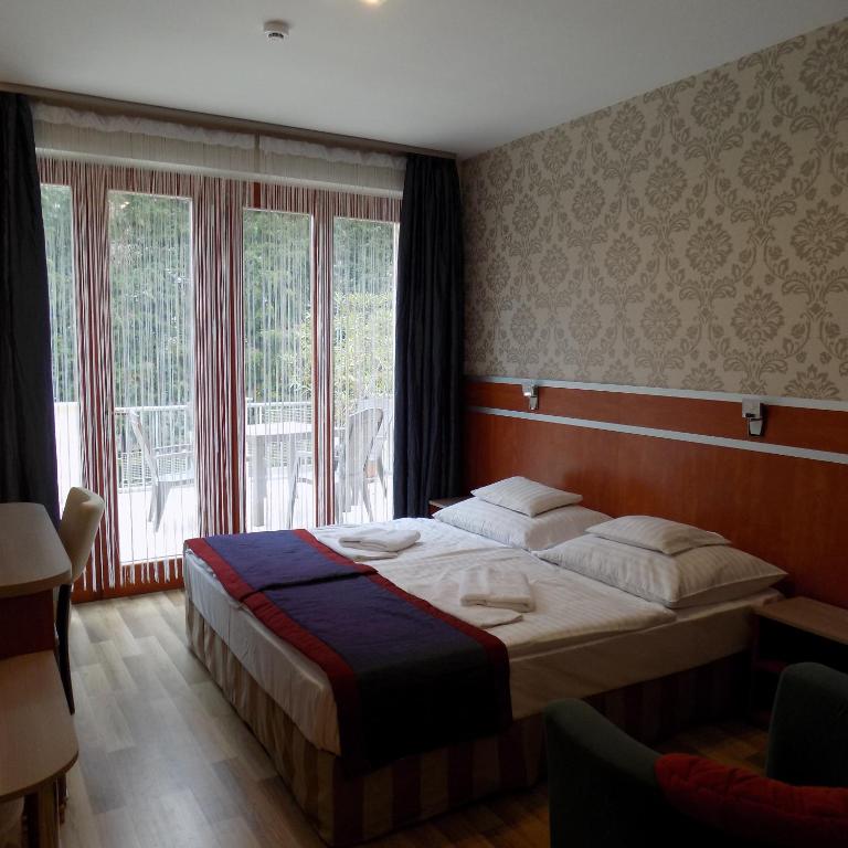 Postel nebo postele na pokoji v ubytování Fortuna Hotel
