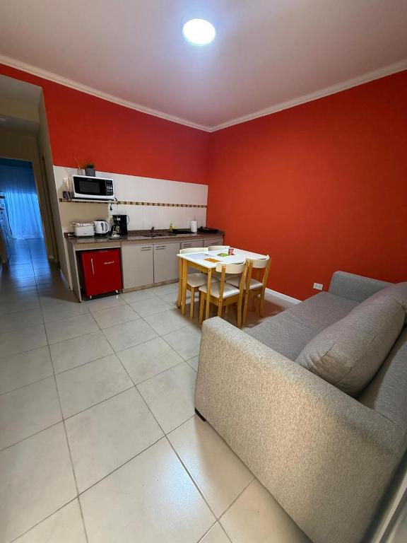 a living room with a couch and a table at Apart Altos Del Pilar in Pilar