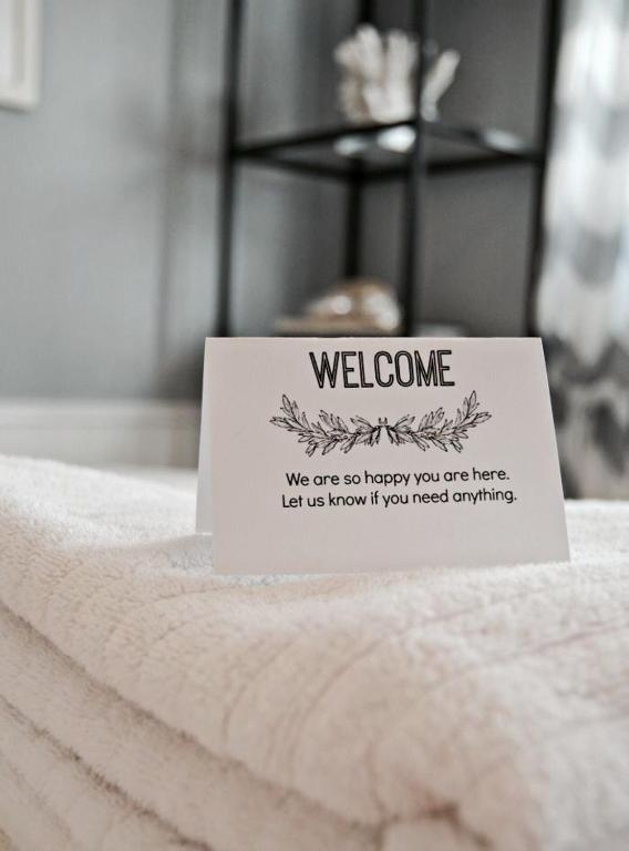 a welcome sign sitting on top of a bed at Villa Amanda and Private Pool in Sampong