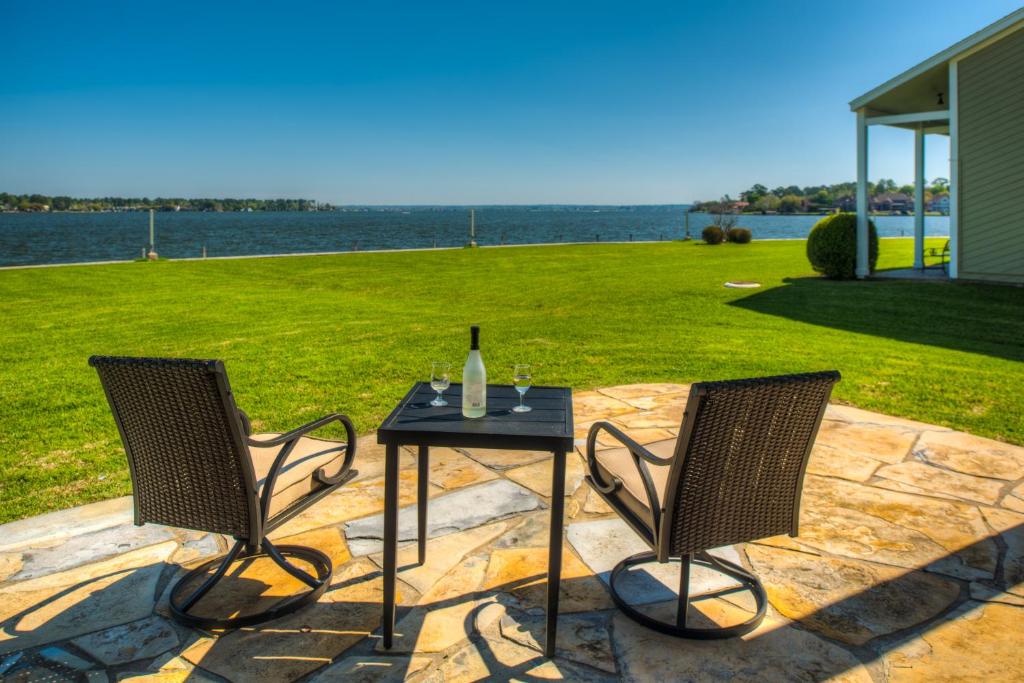two chairs and a table with a bottle of wine at Lake Vibes with Champagne Views in Montgomery