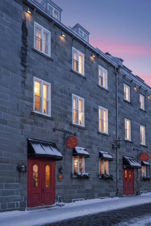 a brick building with red doors on a street at Le Clos Saint-Louis - Par Aneyro in Quebec City
